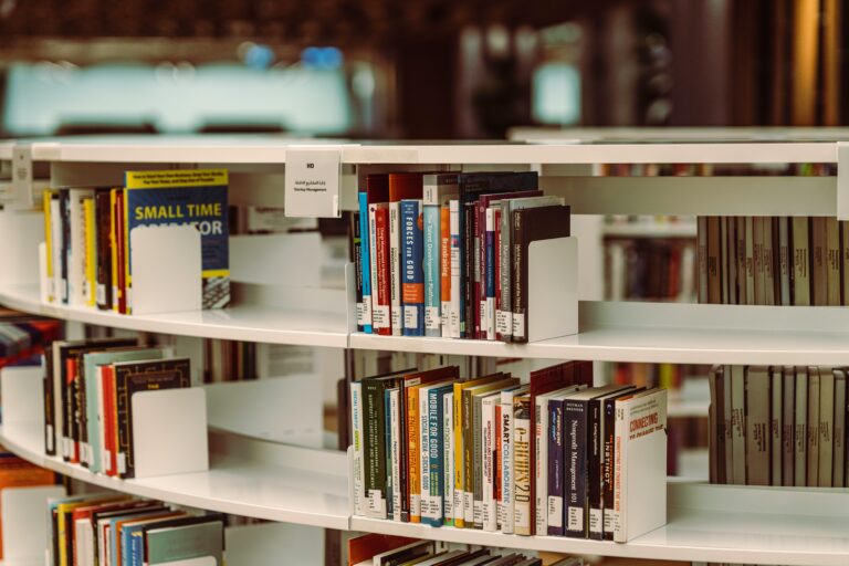 Curved bookshelves filled with books, highlighting a library's modern interior in Dubai.